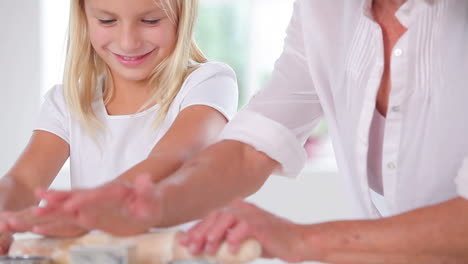 Granddaughter-making-biscuits-with-her-grandmother