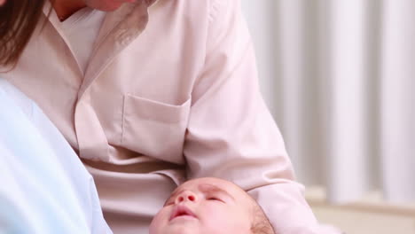 Smiling-man-and-woman-holding-a-new-born-baby