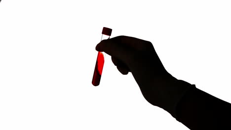 Hand-shaking-test-tube-of-blood-on-white-background