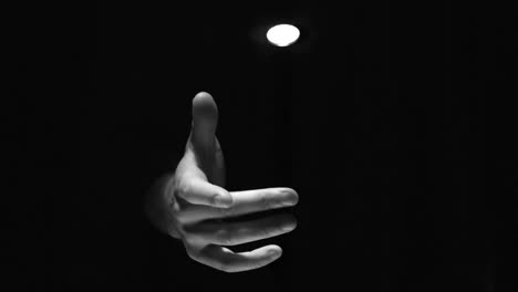 Hand-flipping-a-coin-in-black-and-white