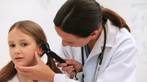 General-practitioner-auscultating-the-ear-of-a-patient-with-a-otoscope