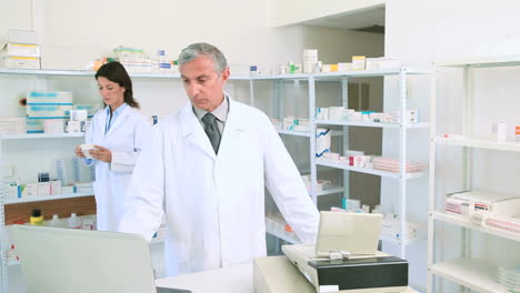 Woman-looking-at-a-box-of-pills