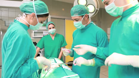 View-of-a-male-nurse-giving-a-scissor-to-a-surgeon