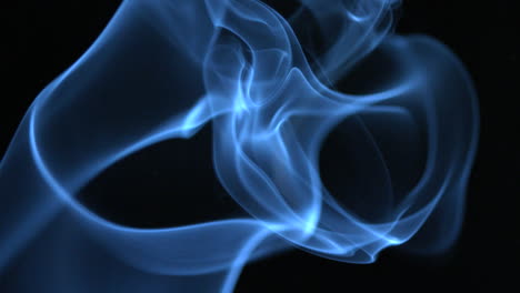 Blue-smoke-rising-on-black-background