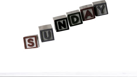 Sunday-spelled-out-in-letter-blocks-falling-over-