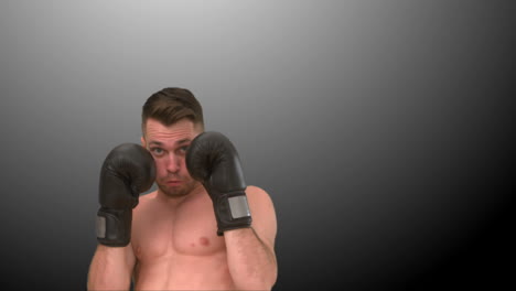 Focused-man-practicing-boxing-on-black-background-