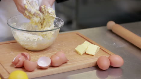 Cook-kneading-dough-in-a-kitchen