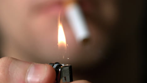 Man-about-to-light-cigarette-with-lighter
