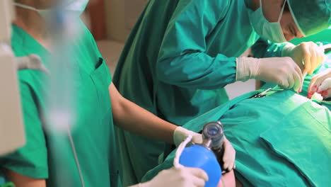 Surgeon-placing-a-resuscitation-bag-on-a-patient