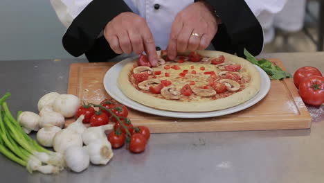 Cook-in-a-kitchen-preparing-pizza