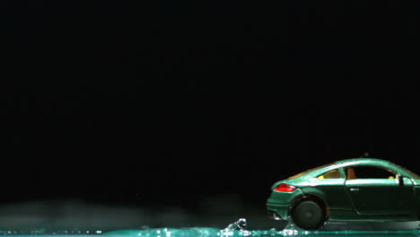 Toy-car-rolling-over-water-and-splashing