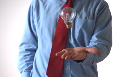 Man-in-shirt-and-tie-throwing-a-light-bulb
