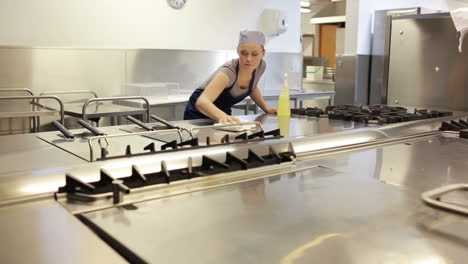 Cleaner-cleaning-a-counter-of-a-kitchen