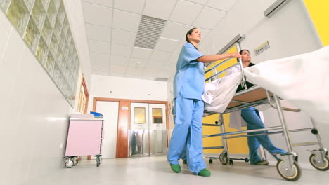 Doctor-and-nurses-driving-a-patient-on-his-bed