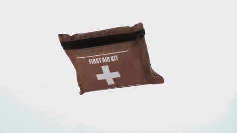 First-aid-kit-falling-on-white-background