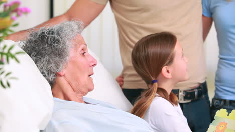 Family-standing-together-around-a-hospital-bed