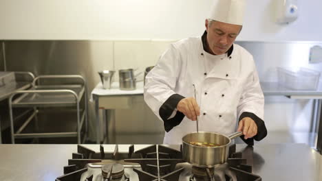 Cook-testing-soup-in-a-kitchen