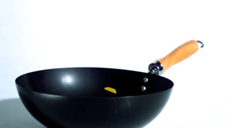 Sliced-yellow-pepper-falling-into-wok
