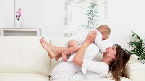 Woman-having-a-baby-on-her-legs-and-plays-with-him