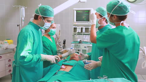 Group-of-surgeon-operating-an-unconscious-patient-in-an-operating-theater