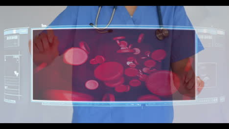 Doctor-scrolling-through-menu-of-medical-videos-of-cells