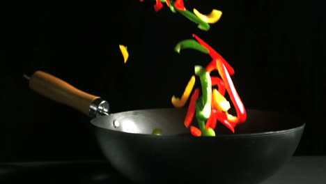 Mixed-sliced-peppers-falling-into-wok