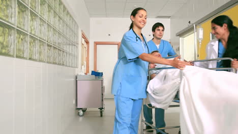 Nurses-driving-a-patient-on-his-bed-with-an-oxygen-mask