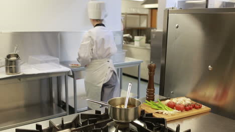 Cook-standing-at-a-stove-while-making-soup