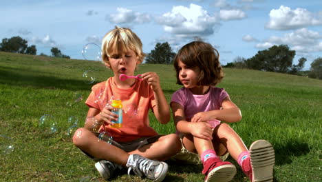 Boy-blowing-bubbles-with-a-girl