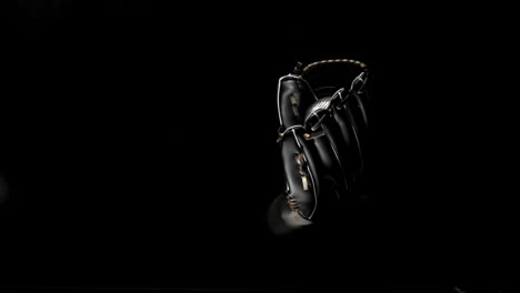 Someone-catching-baseball-in-a-mit-on-black-background