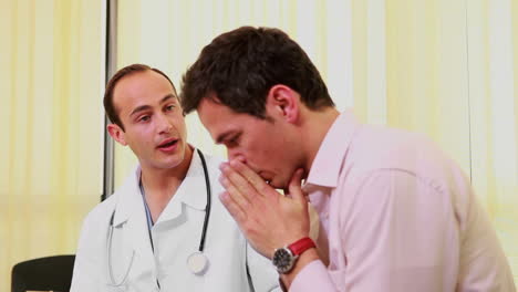 Doctor-talking-to-a-patient-while-they-sit-in-a-waiting-room