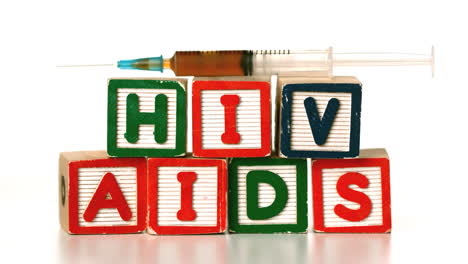 Needle-falling-on-blocks-spelling-AIDS-and-HIV