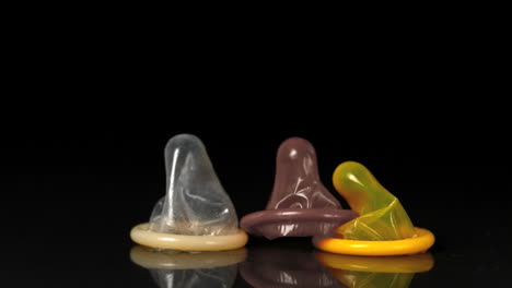 Condoms-dropping-down-on-black-background