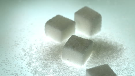 Sugar-cube-falling-onto-pile-of-cubes-and-powder-sugar