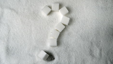 Fragezeichen-In-Zuckerwürfeln-Auf-Einem-Zuckerhaufen