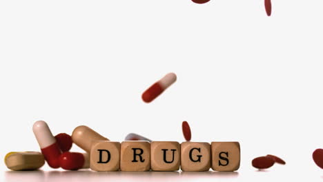Different-tablets-pouring-on-dice-spelling-drugs