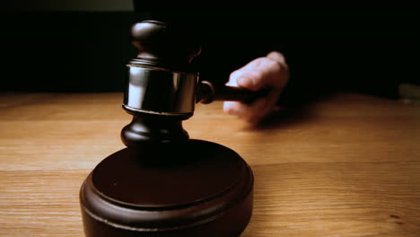 Judge-hammering-gavel-onto-sounding-block