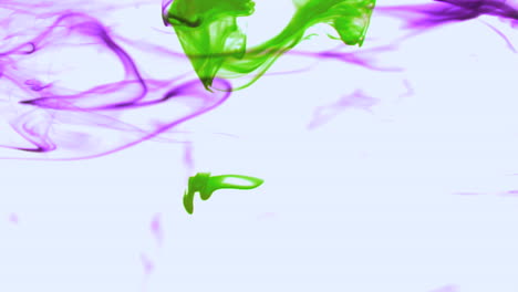 Purple-and-green-ink-swirling-in-water