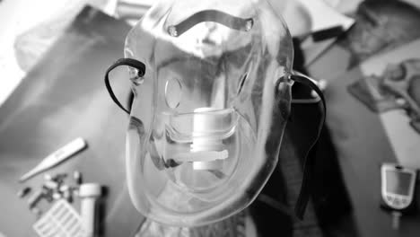 Medical-mask-falling-over-medical-tools-in-black-and-white