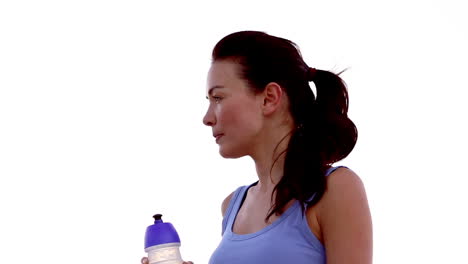 Woman-drinking-water-on-the-beach