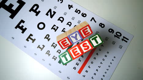 Colorful-blocks-spelling-out-eye-test-falling-onto-eye-test