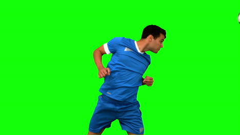 Attractive-man-heading-a-football-on-green-screen