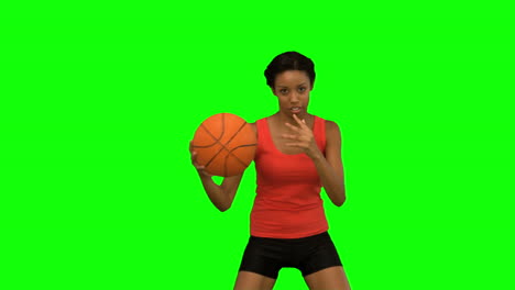 Pretty-woman-playing-basketball-on-green-screen