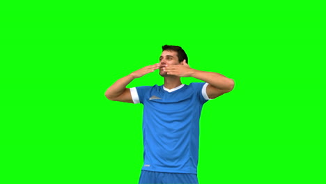 Football-player-waving-a-kissing-at-people-on-green-screen