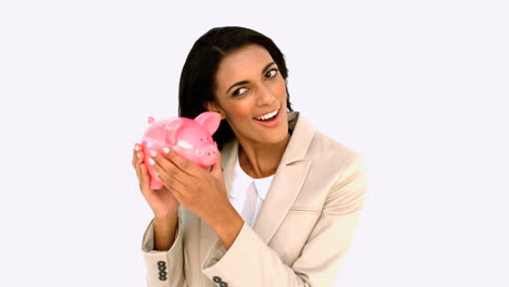 Businesswoman-shaking-piggy-bank
