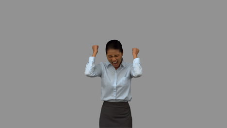 Happy-businesswoman-gesturing-on-grey-screen