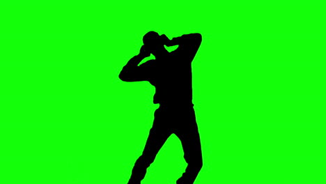 Silhouette-Eines-Mannes,-Der-Springt-Und-Musik-Auf-Einem-Grünen-Bildschirm-Hört