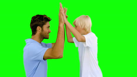 Man-giving-high-five-to-his-son-on-green-screen
