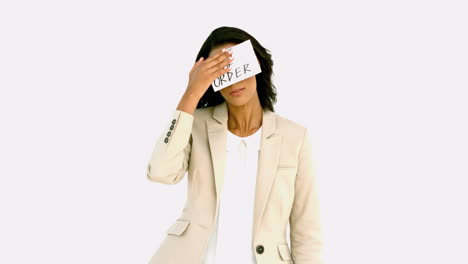 Exhausted-businesswoman-sticking-out-of-order-sign-on-her-forehead