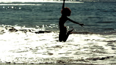 Woman-running-and-jumping-into-the-sea